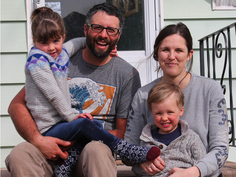 Rory Fraser and family sitting on the front porch at home in Sackville.
