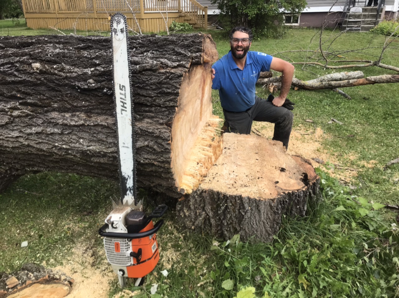 Rory Fraser next to a fallen tree.