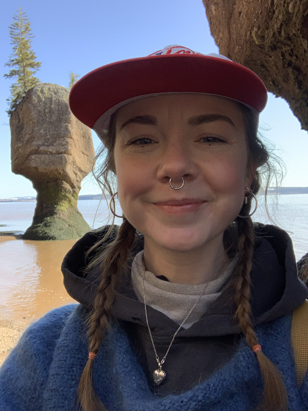 Jess Paget smiles, Hopewell Rocks are in the background
